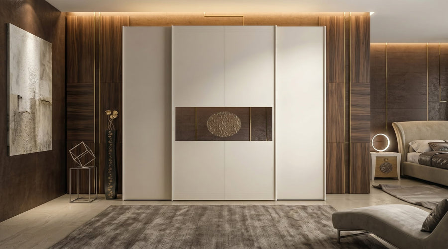 The 864 wardrobe in a bedroom with a dark wood wall: the bronze mirror band and the oval carved at the centre