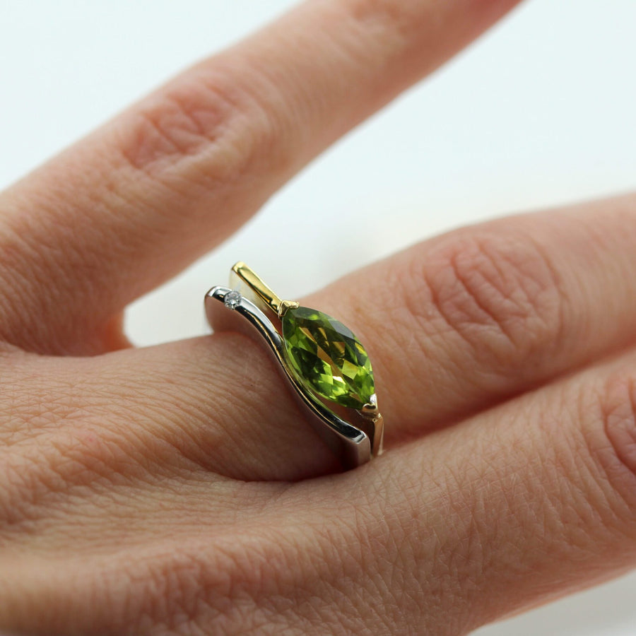 The ring on the finger, the green of the peridot in grazing light
