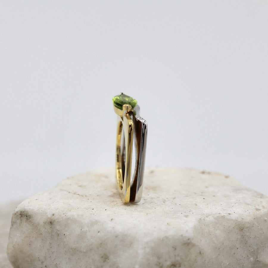 The ring from the front: the two bands side by side and the peridot suspended at the top