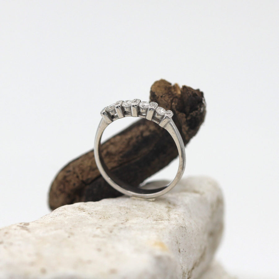 The ring standing next to a piece of wood, the setting in three-quarter view
