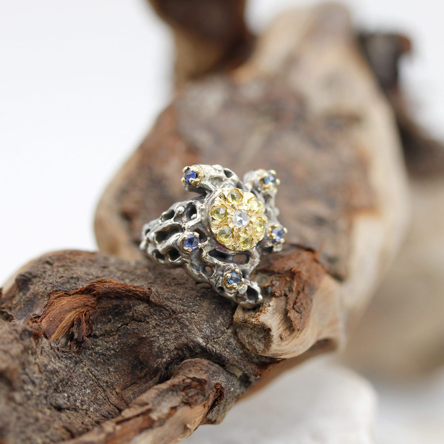 Close-up on wood: the circle of seven yellow sapphires around the diamond