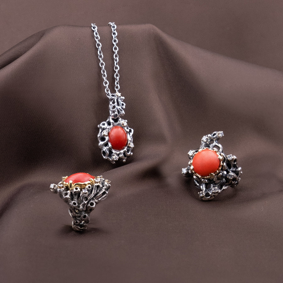 Marte collection shot: this ring on the right, next to a pendant and a ring with the oval coral