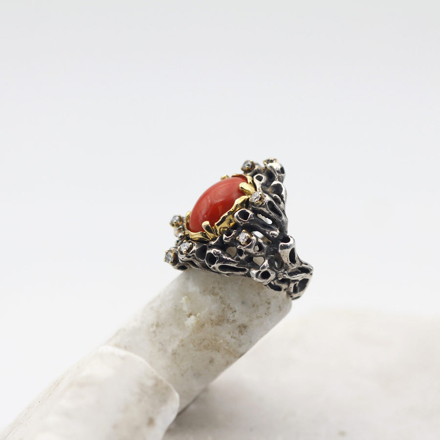 The ring standing on a light stone, the bezel foreshortened