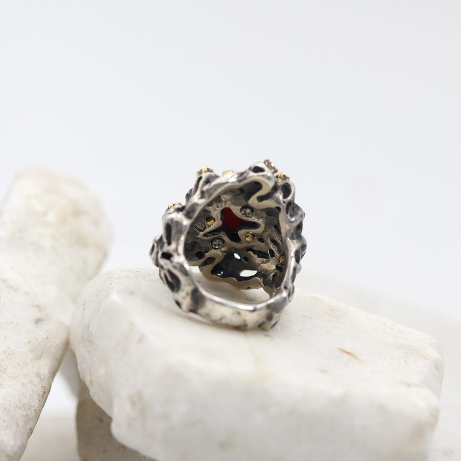 The ring from behind: the red of the coral shows through the silver openwork