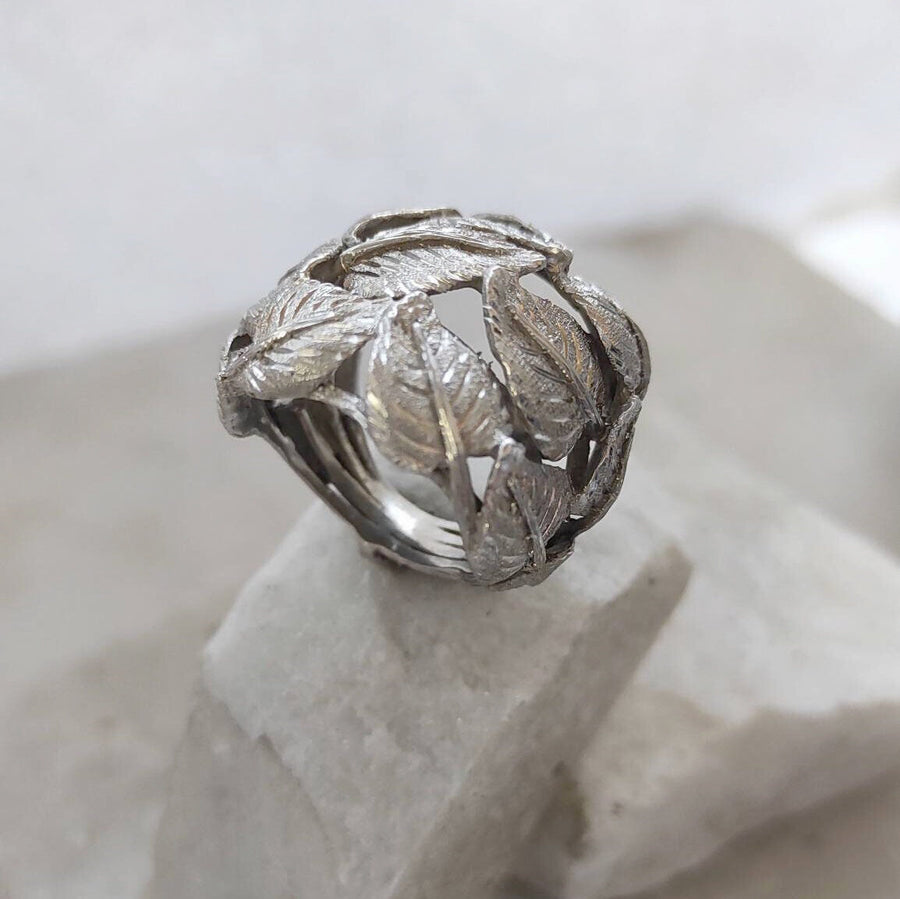 The ring resting on a light stone, three-quarter view