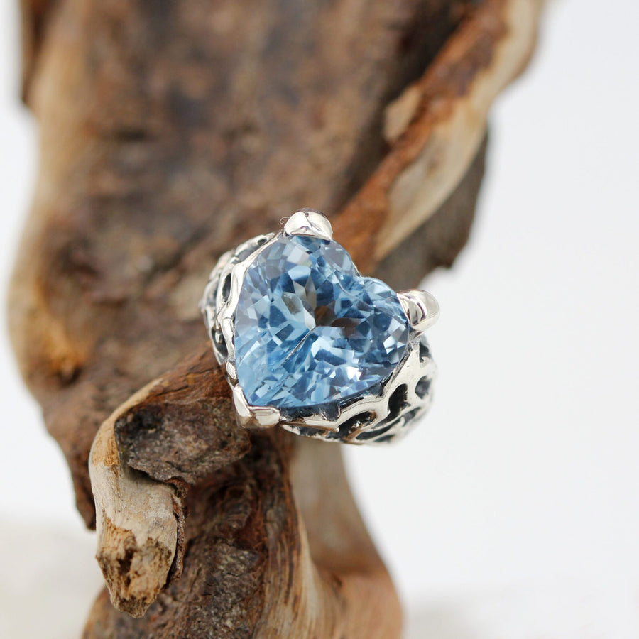 The ring resting on a piece of wood, the heart in close-up