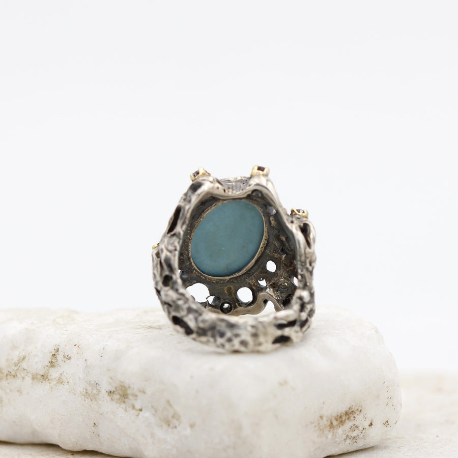 From inside the ring the rough back of the turquoise shows through the open base