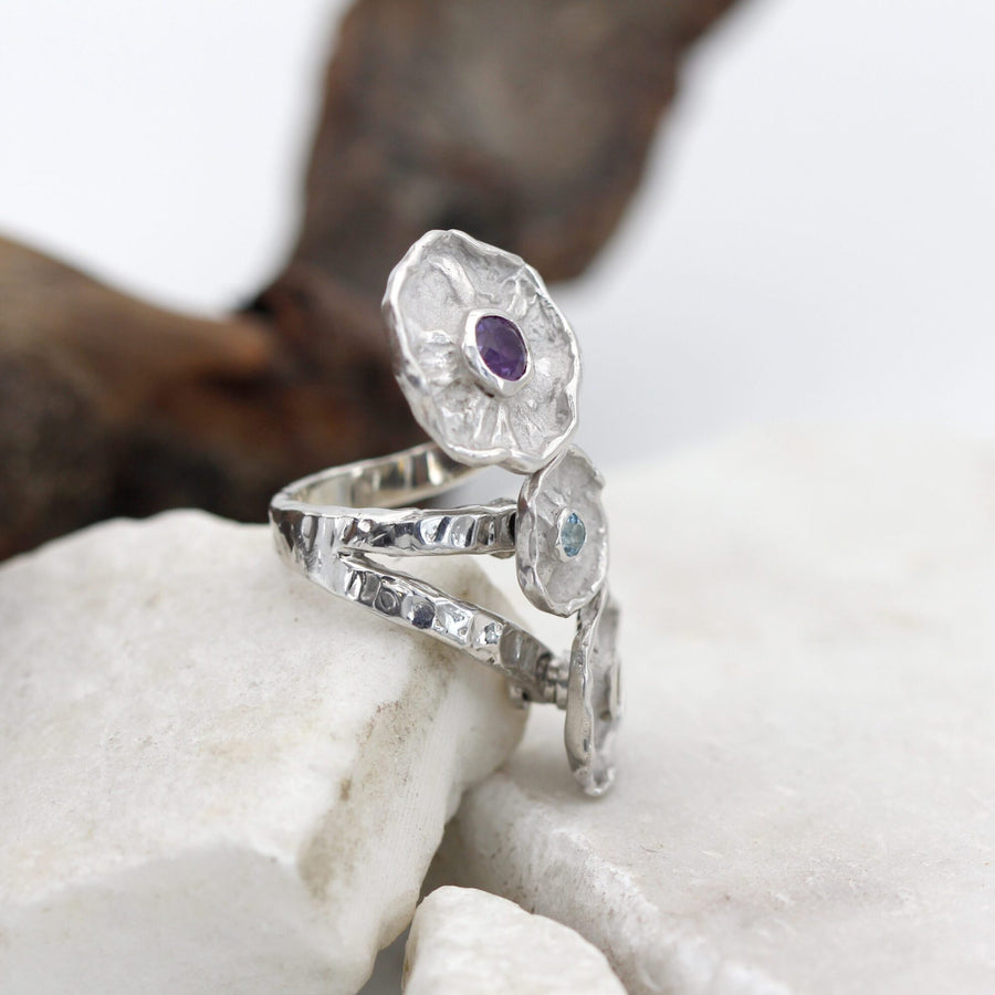 The ring resting against a branch: the hammered texture of the band in full light
