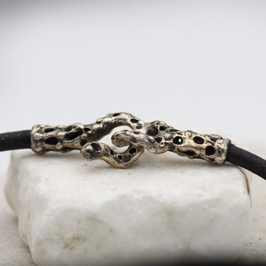 The clasp open: the two pierced silver tubes, the hook and the eye