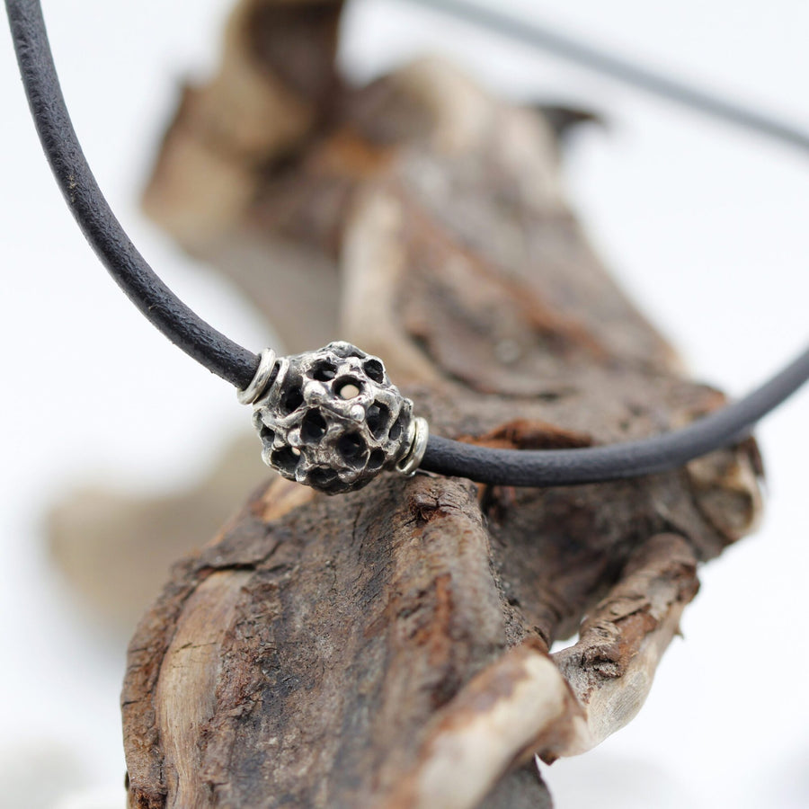 The choker resting on a dry branch