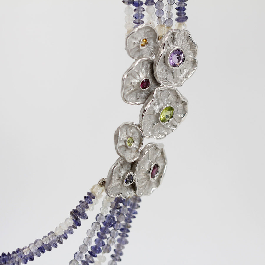 Close-up of the hanging strands: the iolite goes from full blue-violet to almost colourless beads