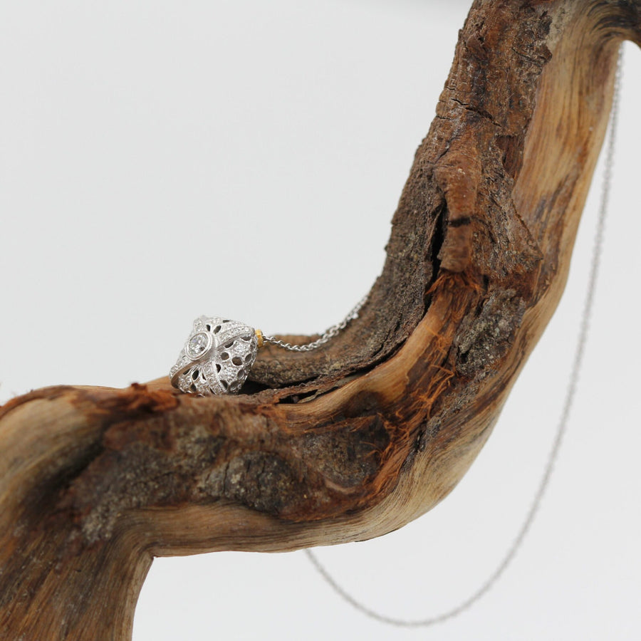 On the wood, with the chain hanging free