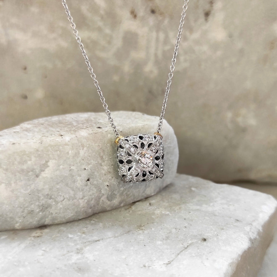 Resting against the stone, the chain rising to one side