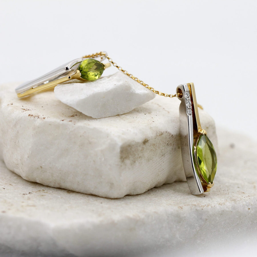 The pendant next to the ring from the same set, on white stone