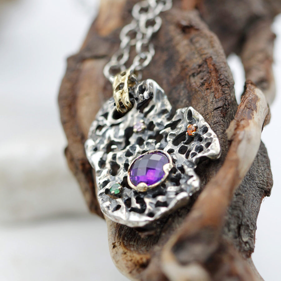 The pendant on a dry branch: the black stays in the recesses, the light on the edges of the openings