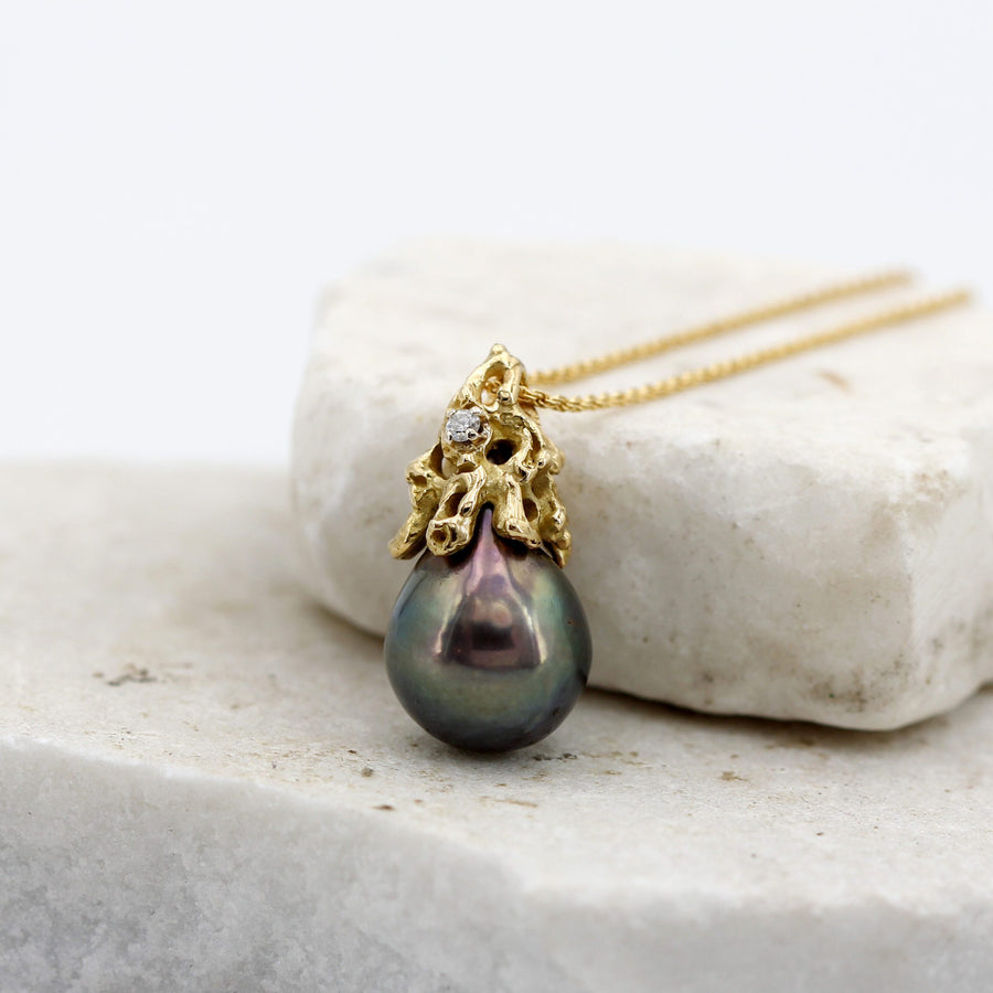 The pendant from the side, resting on the edge of the marble
