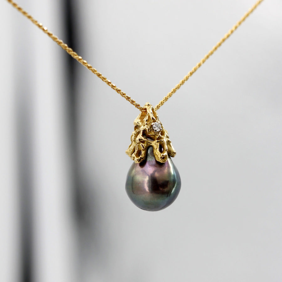 On a dark background: the green and bronze flashes on the edge of the pearl