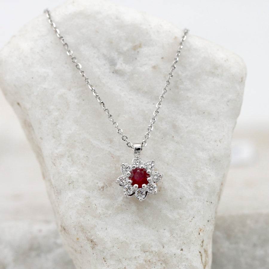 Resting against an upright white stone: the chain runs down and the rosette stays at the bottom