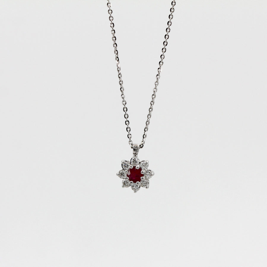 On a white background, the whole necklace: the chain, the flat bail and the flower of stones