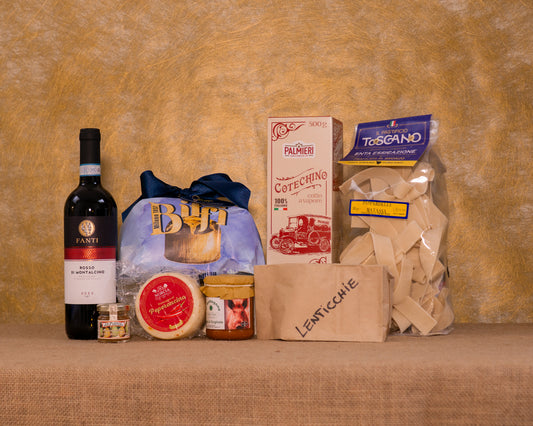 I 8 prodotti del cesto «Festa Classica» disposti sul fondo di juta, fra cui Panettone tradizionale Biffi, Rosso di Montalcino DOC Fanti e Pappardelle Pastificio Toscano, e gli altri.