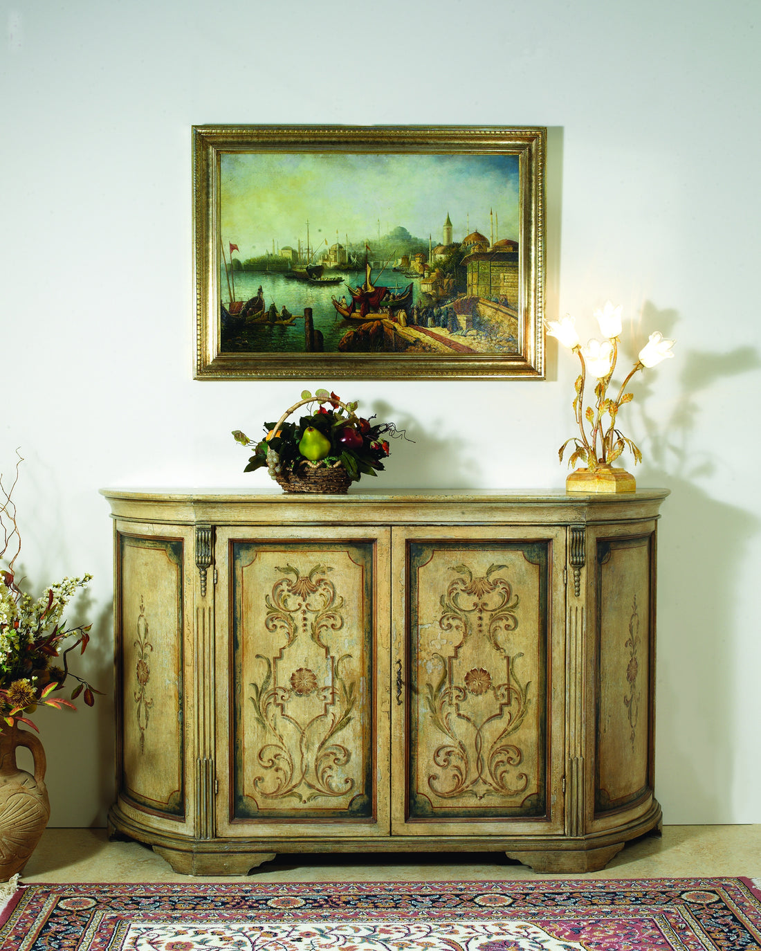 The 415 sideboard against a light wall, with the curved front and the blue and brick scrollwork painted on the taupe ground
