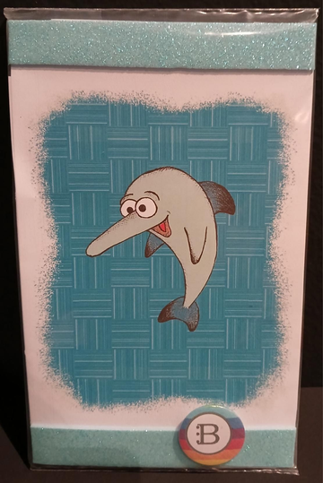 Il quadretto con il Delfino e la spilletta Bookendipity, nella confezione