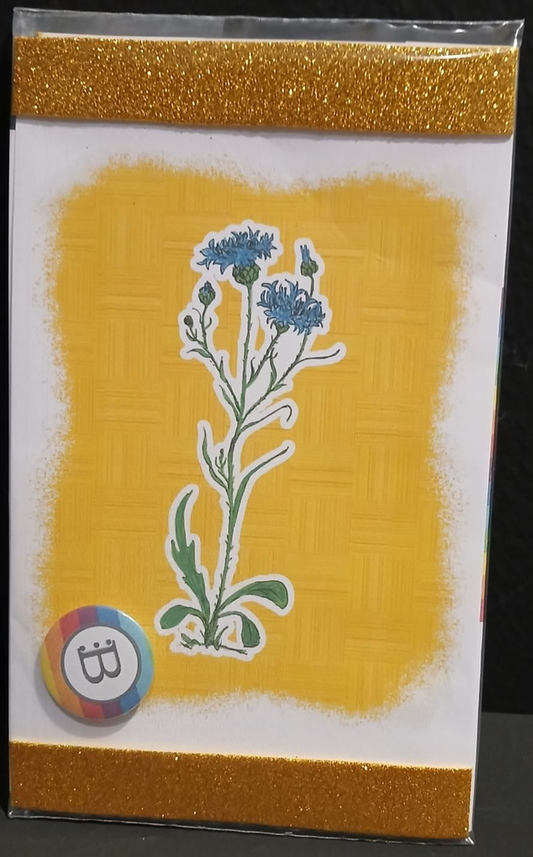 Il quadretto con il Fiordaliso e la spilletta Bookendipity, nella confezione